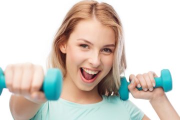 smiling beautiful young sporty woman with dumbbell